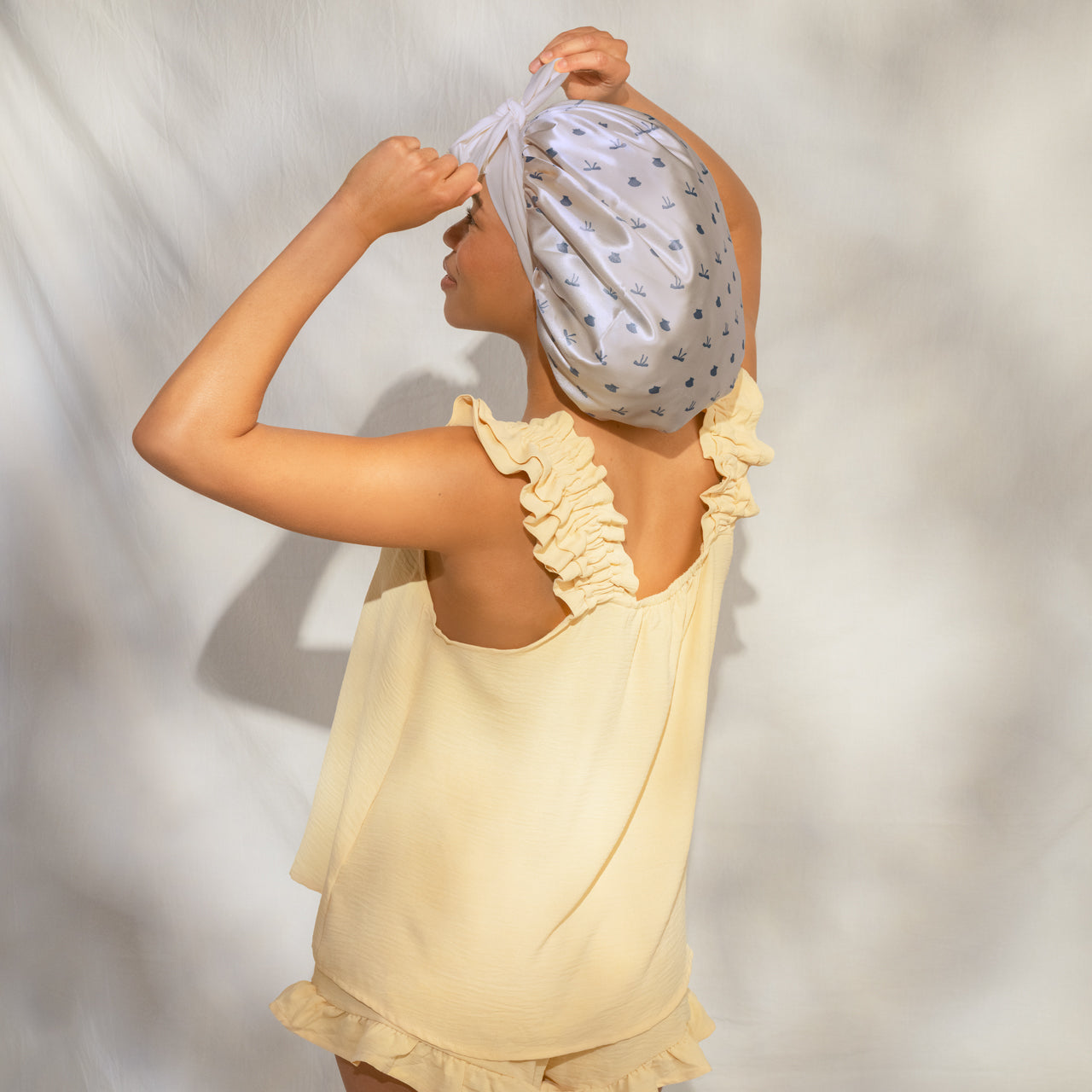 509518-CoastalCottage-OversizedSatinBonnet-PearlizedCream_CoastalBlue-Model-3-1280x1280px